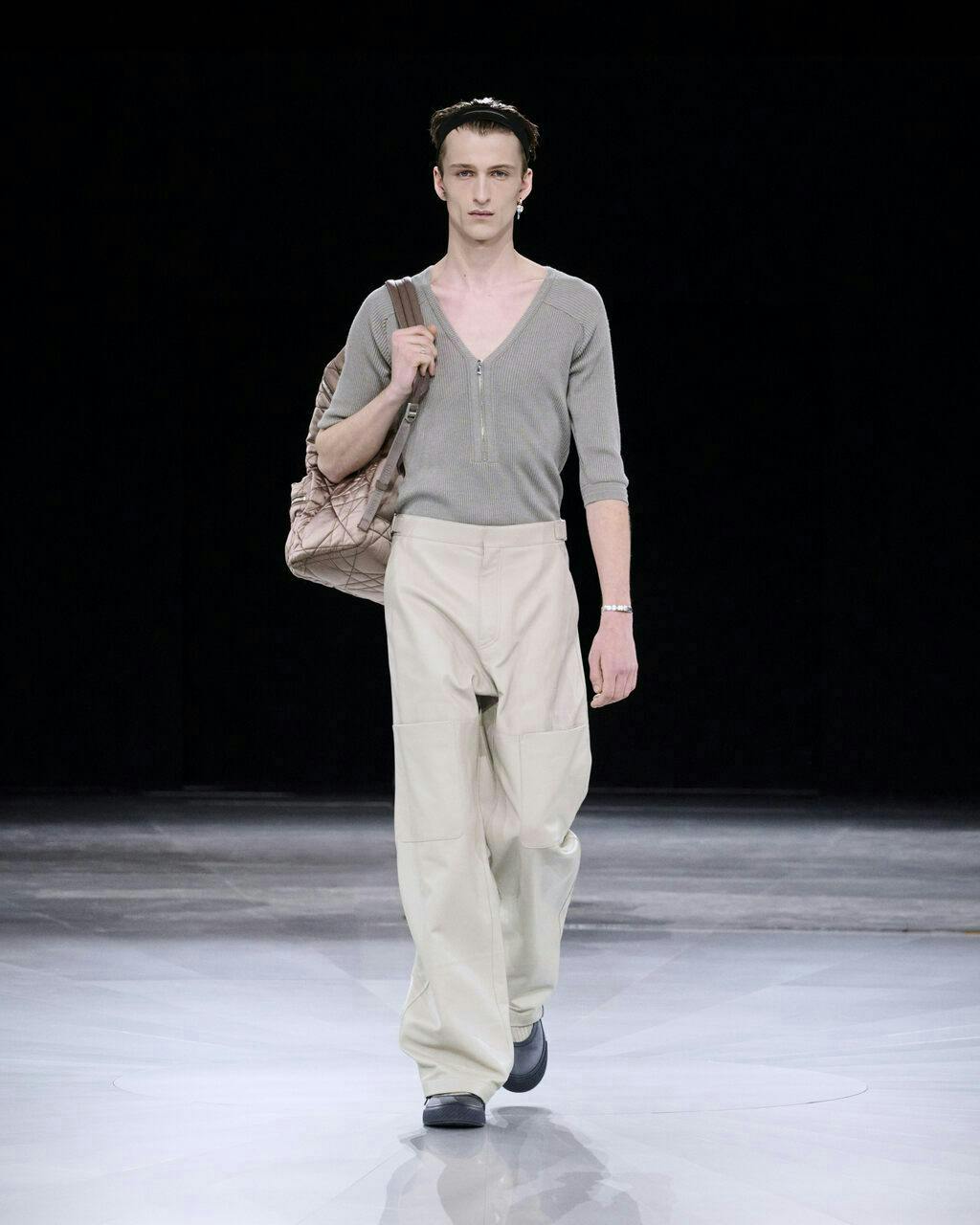 fashion adult male man person handbag standing pants long sleeve face