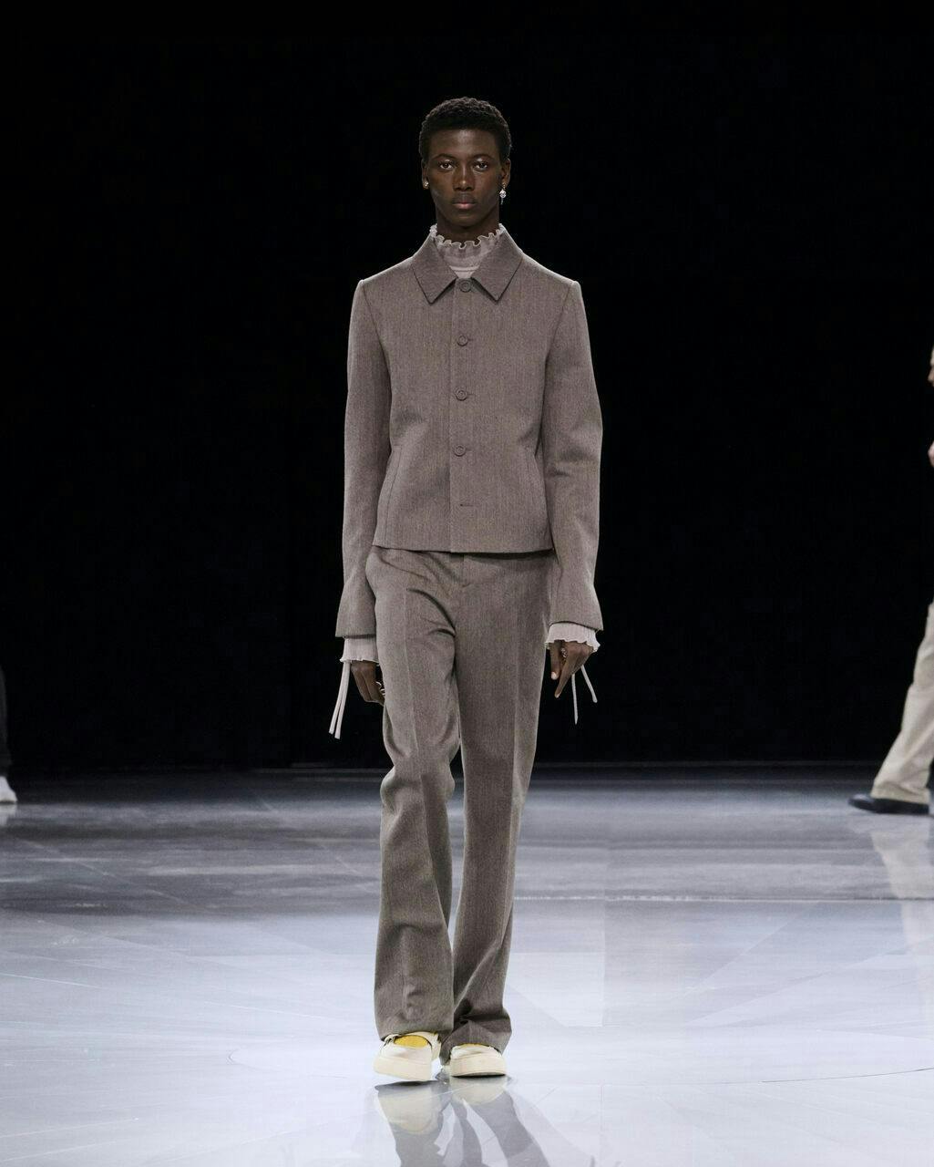 fashion adult male man person coat standing suit pants shoe