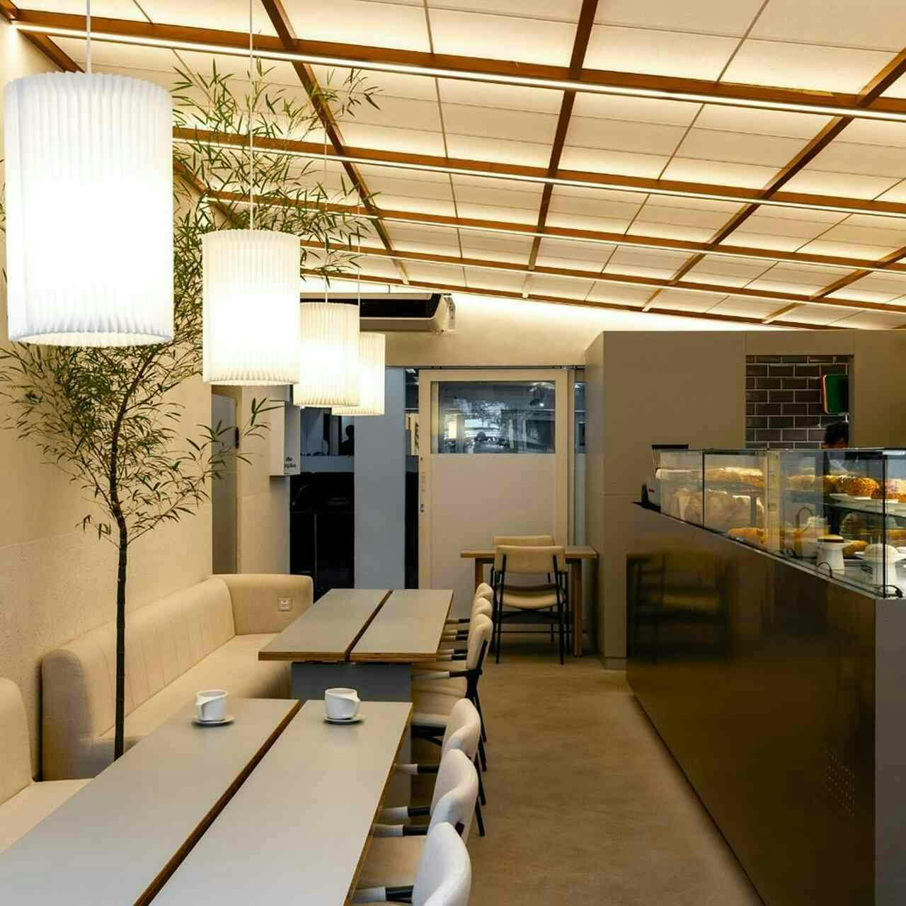 indoors restaurant desk cafeteria dining table dining room plate person interior design lighting