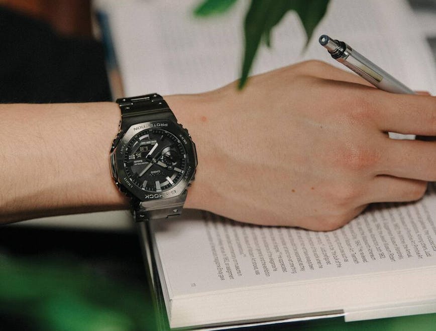 person writing wristwatch pen
