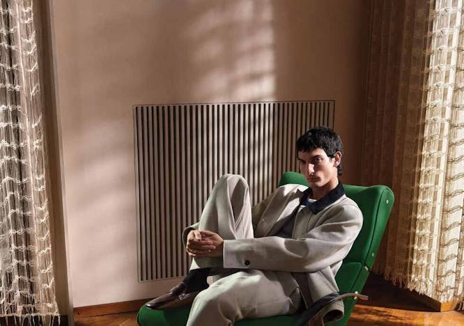 person sitting adult male man furniture head