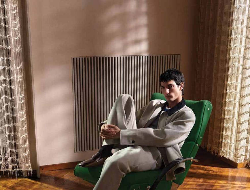 person sitting adult male man furniture head