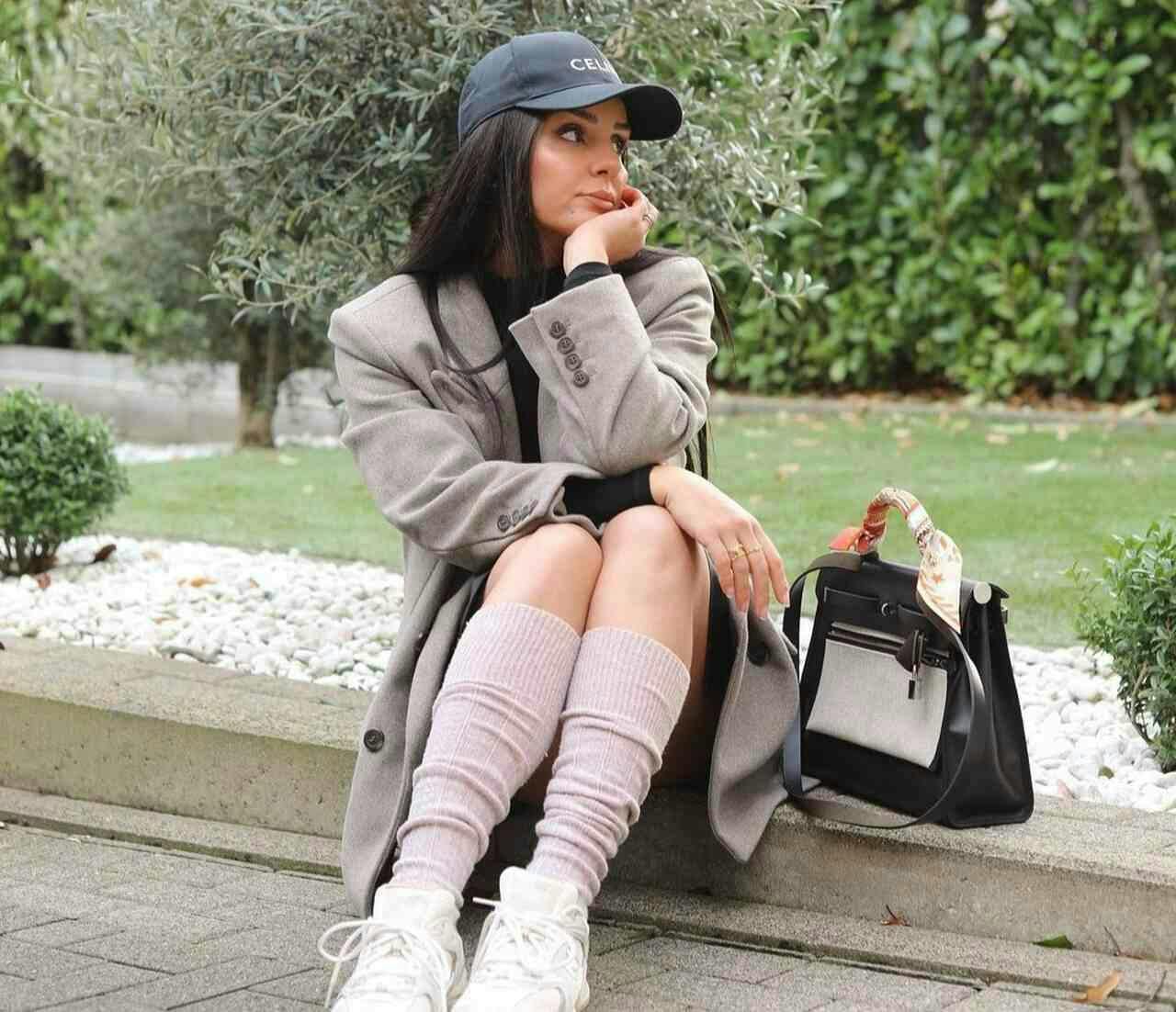 person sitting bag handbag female girl teen coat face head